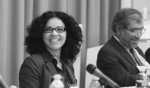 Mona Eltahawy and Khalil Shikaki seated behind microphones at a panelists' table.