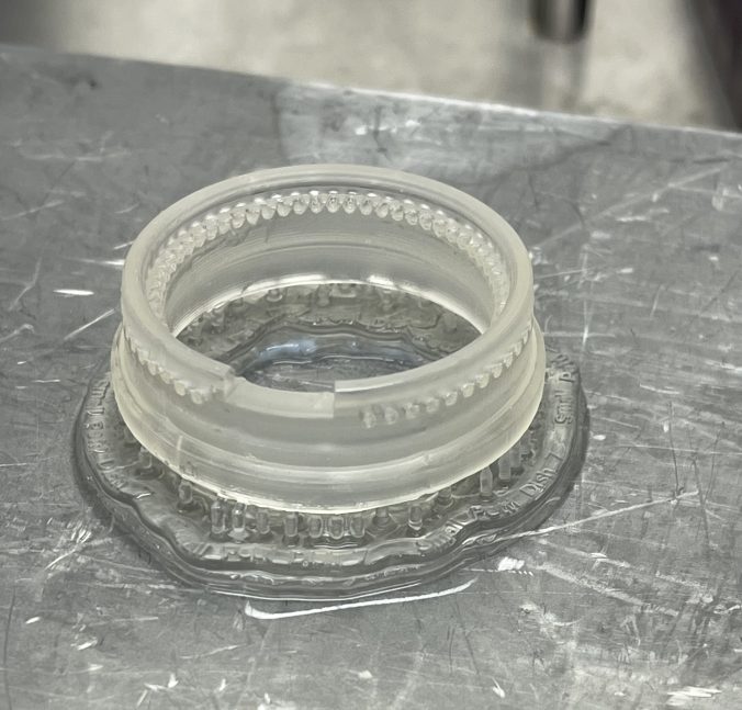 Functional testing print on metal printing platform. Captured after washing and curing but before removal from printing platform. Includes details like ventilation holes, 'bridge' cut out, and rounded upper lip.