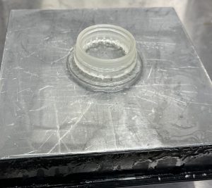 Completed Petri Dish Holder Testing Print, attached to the metal printing platform. Captured after washing and curing but before removal from metal platform.