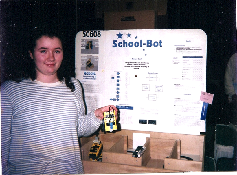 Jennifer in her sixth-grade science fair presenting School-Bot, a robot courier for schools, built with LEGO MINDSTORMS. She is still interested in developing robots for schools almost two decades later.