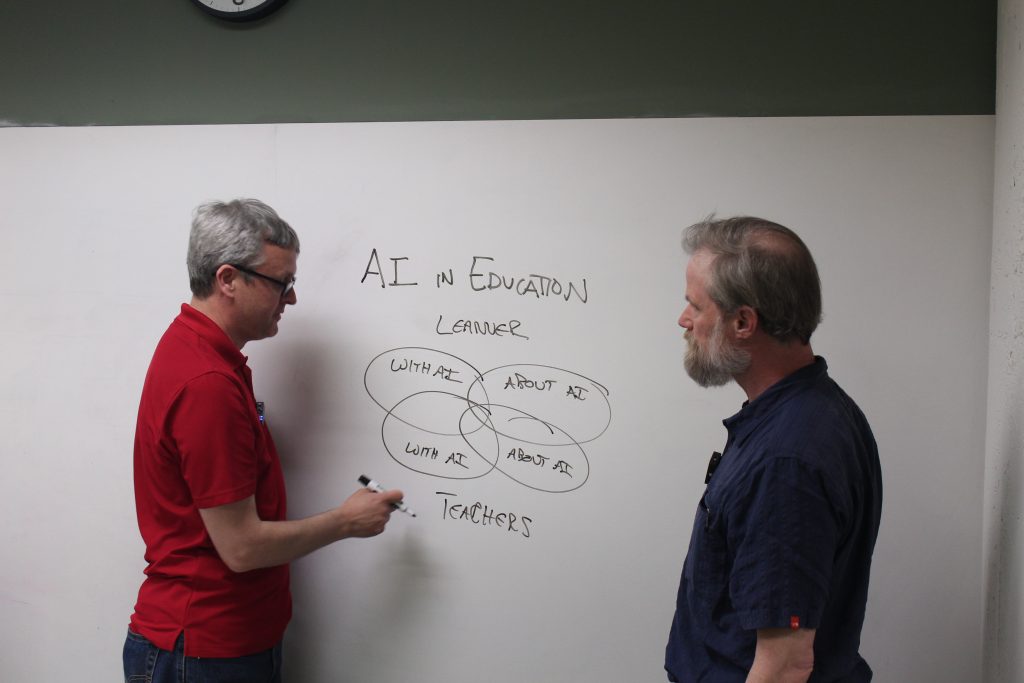 Ethan and Bill in front of whiteboard, outlining AI course in Venn diagram