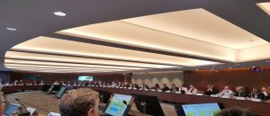 Photo of people sitting around a large circular table with tablets in front of them at IEA conference workshop