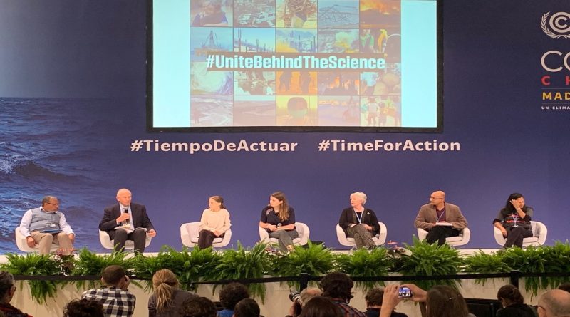 Photo of Bill Moomaw speaking on a panel with 6 other people at COP 25