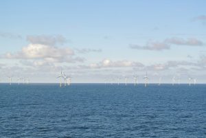 Landscape photo of the horizon line of the North Sea and background of blue sky and clouds