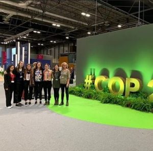 Photo of Fletcher IERP students in front of COP 25 logo statue