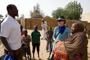 Photo of Jenny Aker speaking with locals in Loga village