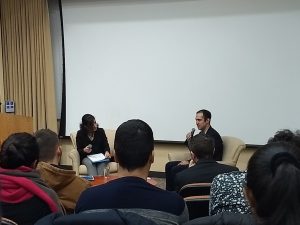 student interviews speaker in front of audience