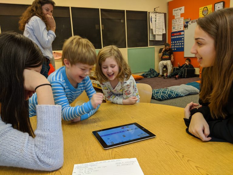 Professor Marina Bers observes the interactions between our children, her CD-145 students, and the technology learning tool, Scratch Jr.
