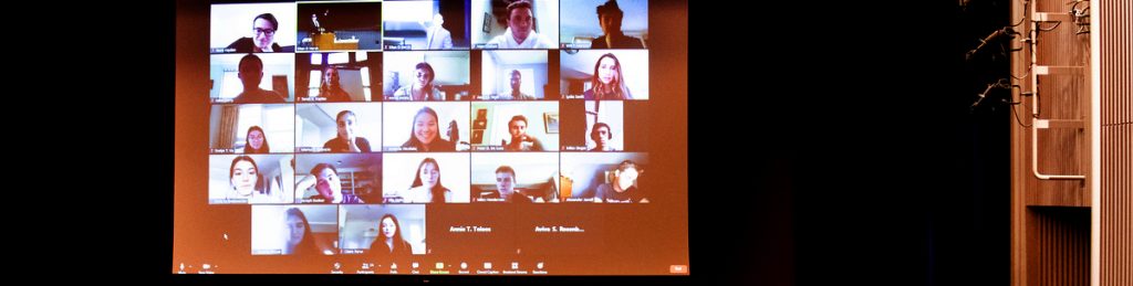 Medford/Somerville, Mass. - Eitan Hersh, Associate Professor of Political Science, teaches class in Cohen auditorium on the first day of the fall semester. Behind him is a section of the class attending via Zoom. (Alonso Nichols/Tufts University)