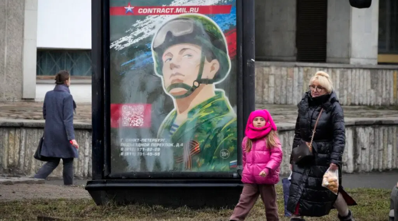 People walk past an army recruiting billboard