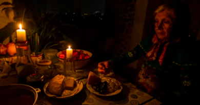 Woman eating dinner by candlelight