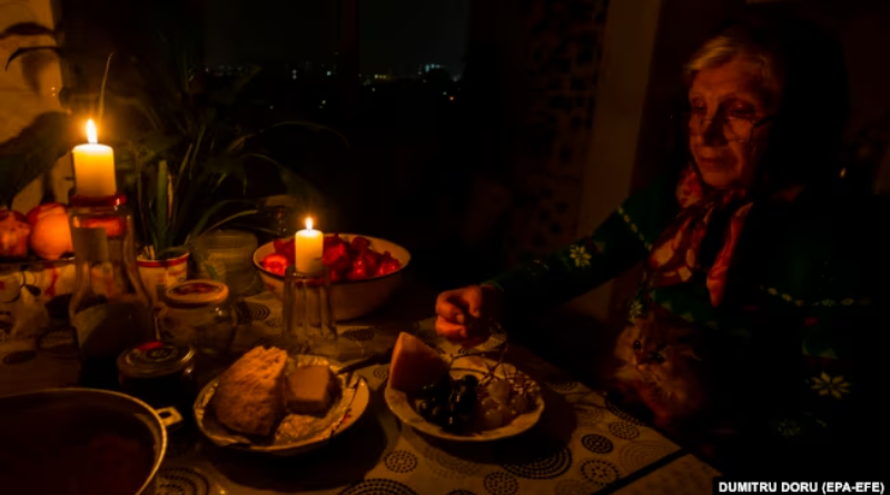 Woman eating dinner by candlelight