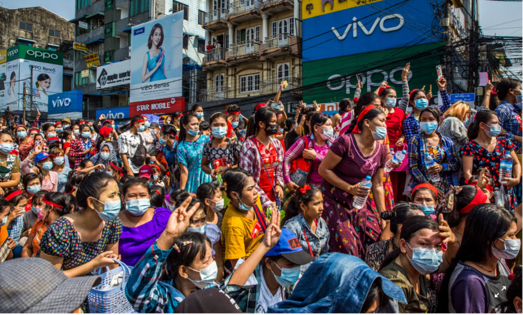 A crowd of people in a street

Description automatically generated with low confidence