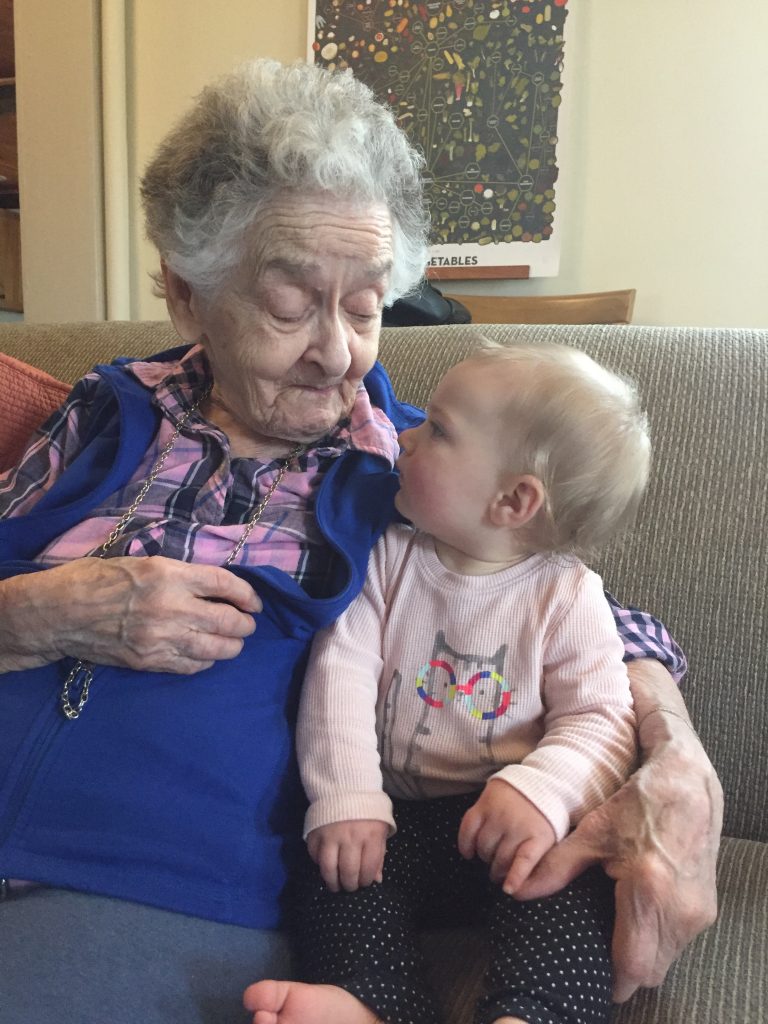 A photograph of Norma Ricci holding Ellen McDonald's granddaughter.
