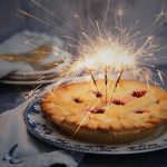 Pie with sparklers lit on top