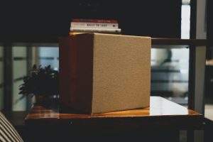 A box on a table with books on top