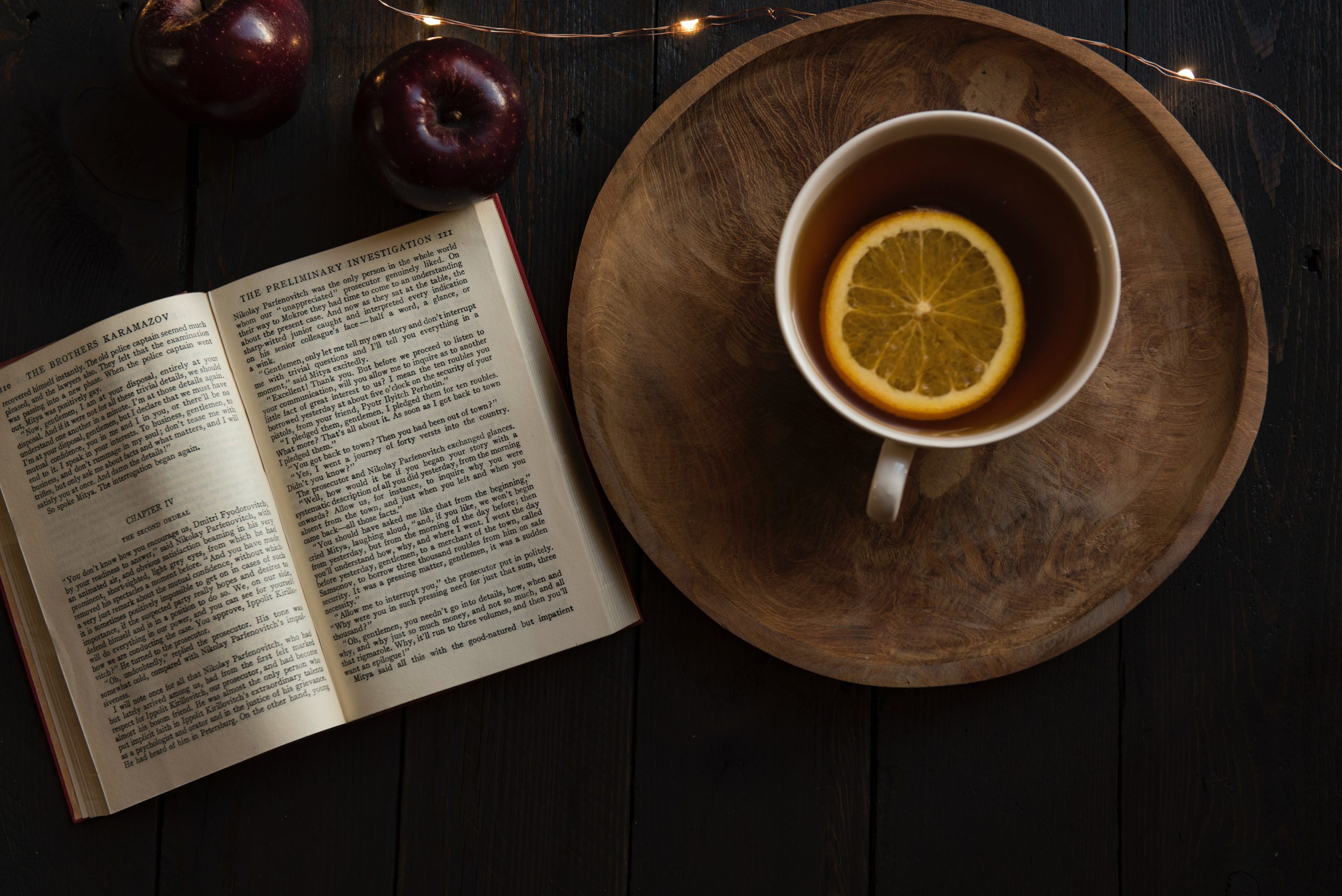 Overhead view of an open book and a cup of tea