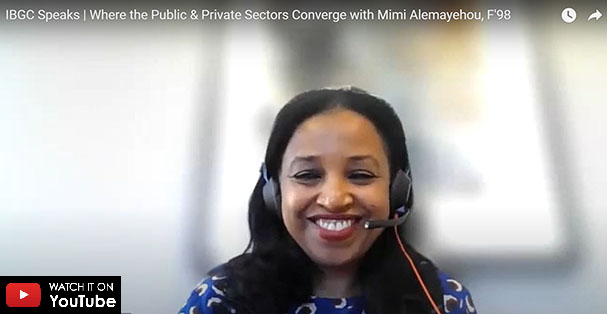 Mimi Alemayehou wearing a blue and white shirt smiling