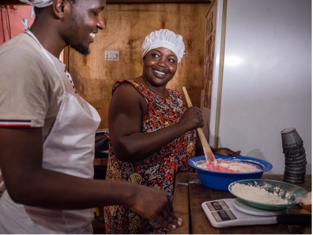 A person cooking food in a kitchen

Description automatically generated with low confidence