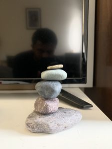 5 rocks of various shapes and sizes stacked on top of one another vertically. The stones are in balance.