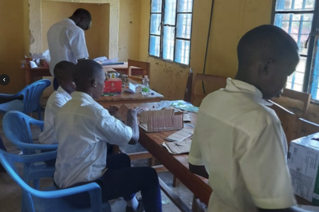 students in Rwanda build things with cardboard