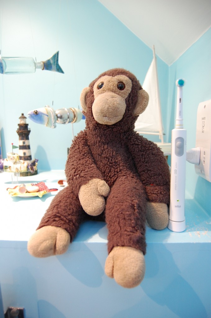 Stuffed monkey with a toothbrush