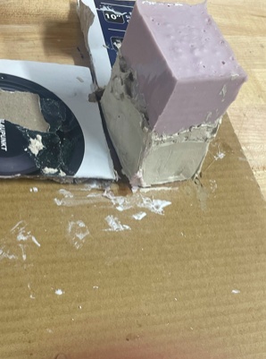 Picture including molding material (alginate) mold formed with clay bottom.
