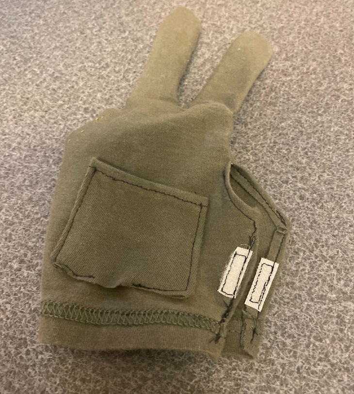 Photo showing the addition of a pocket for the circuit component and velcro to the glove.