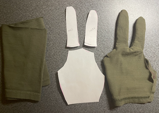 Photo showing the design process of making and sewing the glove using cotton material.