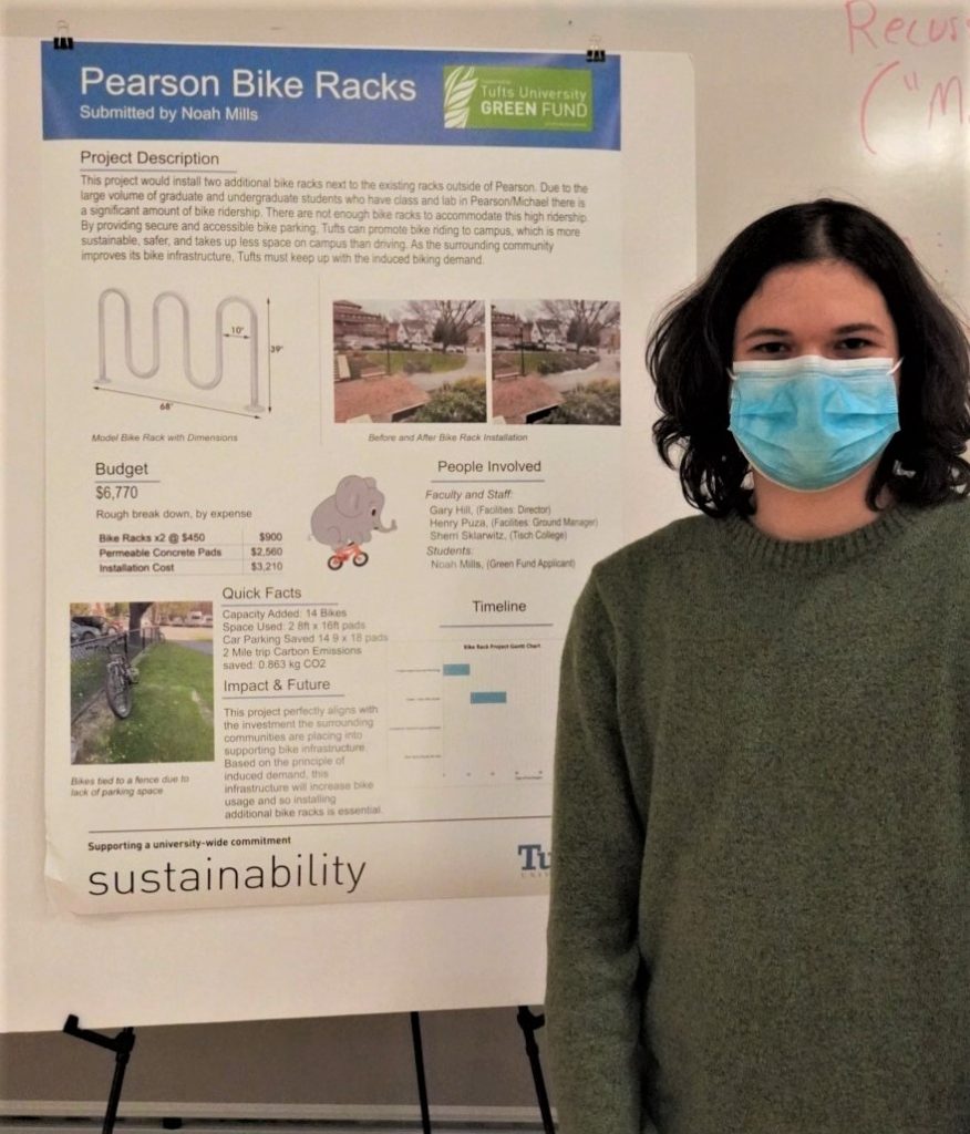 A Man stand in front of a poster explaining a bike rack installation project.