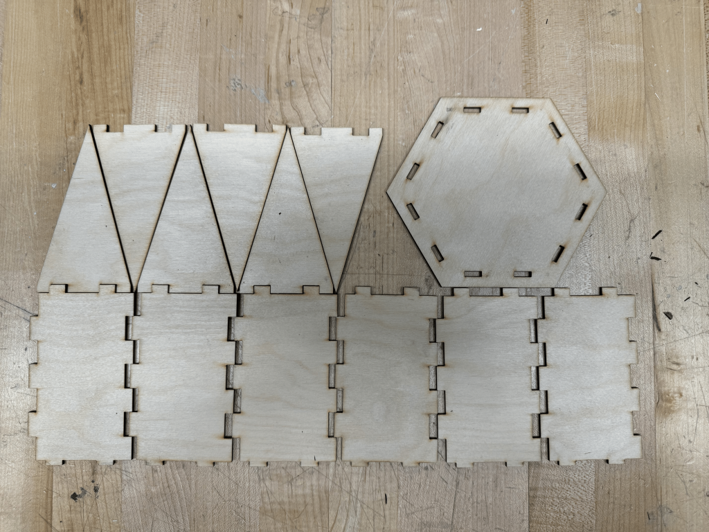 A picture of the laser cut pieces of the 3D circus tent.
