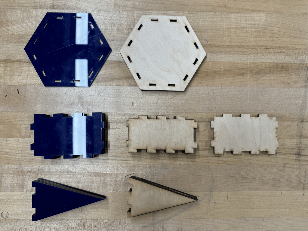 A picture of the stacks of laser cut pieces from previous iterations.