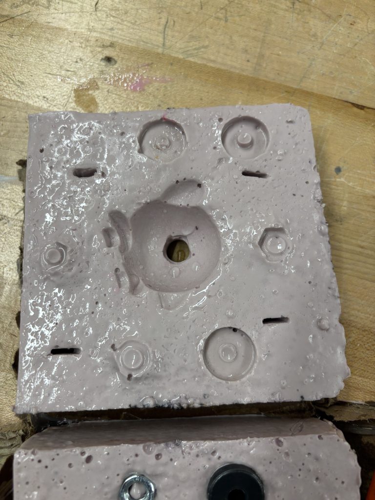 A picture of the top of the Kirby mold with guide pieces imprinted.